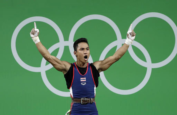 Sinphet Kruaithong, of Thailand, celebrates a successful lift in the men's 56kg weightlifting competition at the 2016 Summer Olympics in Rio de Janeiro, Brazil, Sunday, Aug. 7, 2016. (AP Photo/Mike Groll)